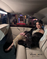 young female adult from bachelorette series wearing gold gown with brown cervinia cashmere fur trimmed cape over her shoulders sitting in back of a limo