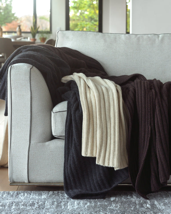 sofa with three Brooklyn Loft Chunky Cashmere Throws in charcoal