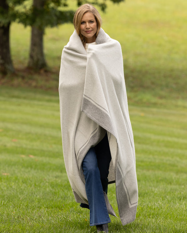 model wrapped in Skyline Border Stripe Cashmere Throw in grey