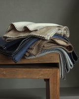 stack of cashmere Gotham Whipstitch Dual-Colored Cashmere Throws in navy-denim