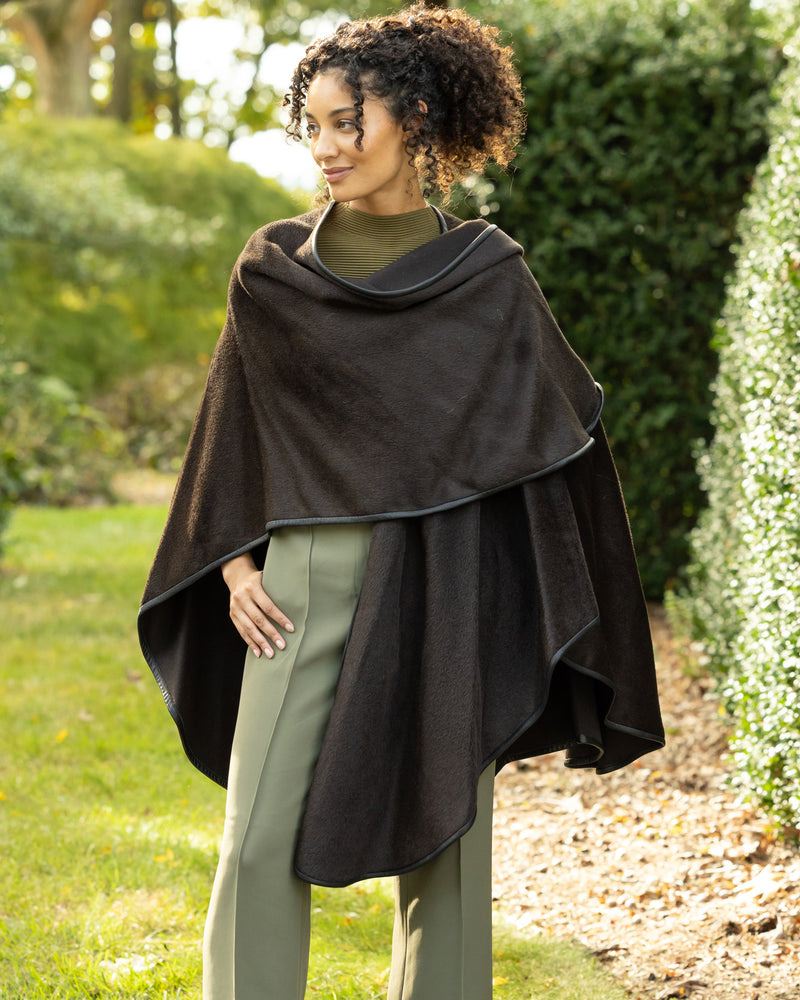 model standing outside wearing Alpaca Wool Cape with Leather trim in Chocolate