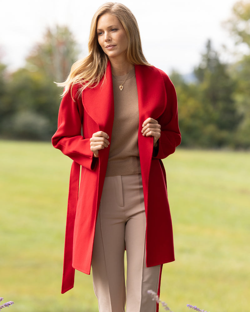 woman walking in a field and wearing Victoria Coat in Red