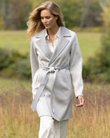 woman walking in field and wearing Cashmere Bella Coat in grey 