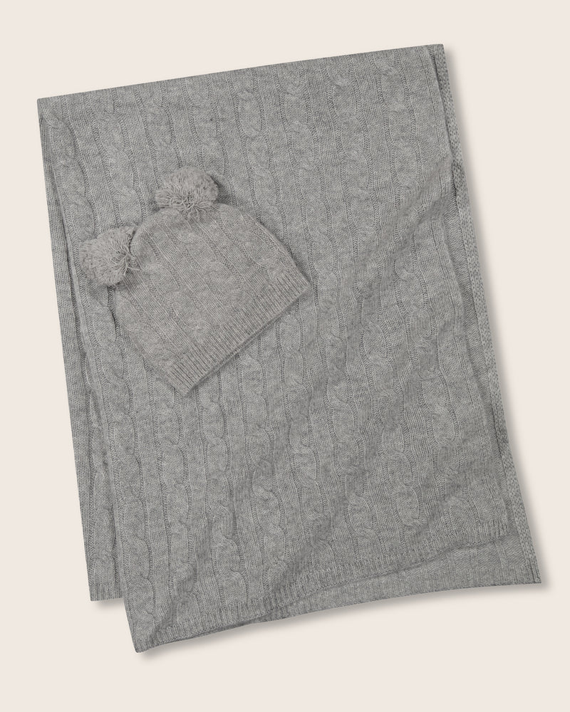 Cable knit baby blanket and pom-pom hat set in light grey