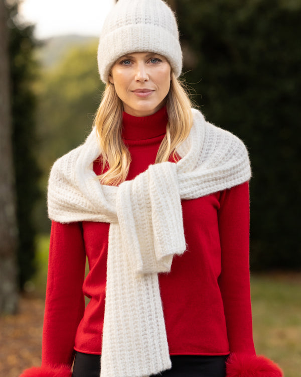 woman wearing red sweater Eleganza chunky boucle scarf and Eleganza Cashmere cuffed knitted beanie in ivory