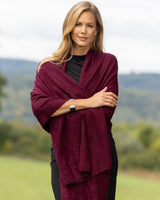 Model wearing Radiant Cashmere Sequin Wrap in burgundy