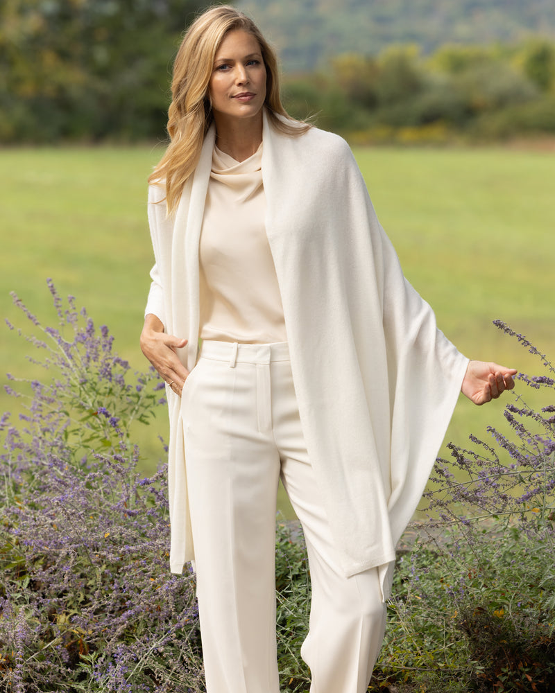 Model wearing Voyage Cashmere Travel Wrap in ivory