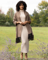 Model wearing Cashmere Wrap with Leather Fringe in Heather Taupe