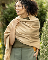 Woman wearing Cashmere water weave wrap with fringe in camel