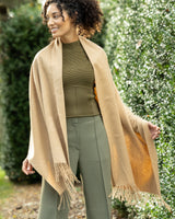 Woman wearing Cashmere water weave wrap with fringe in camel