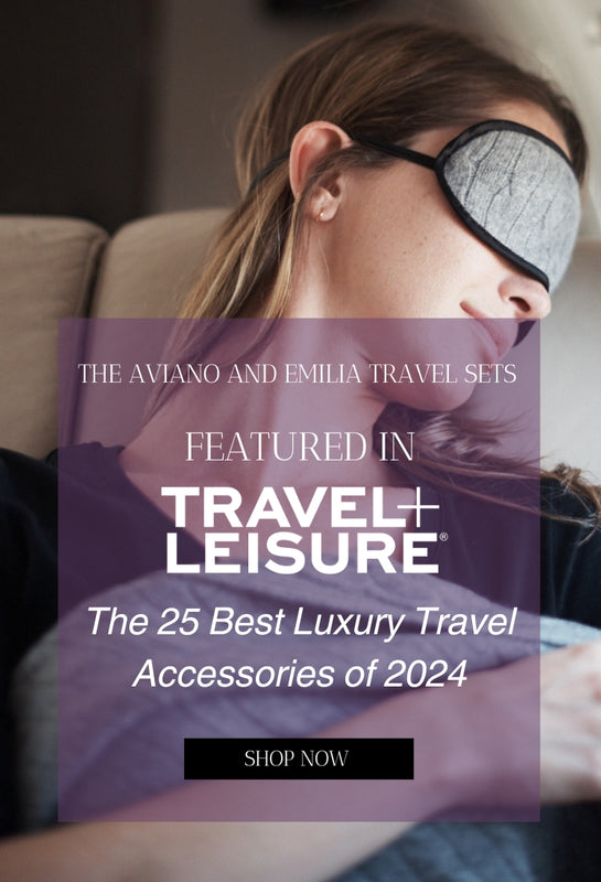 the aviano and emilia travel sets as featured on travel and leisure the 25 best luxury ravel accessories of 2024 show now. background image of woman sleping on plane in sleep mask